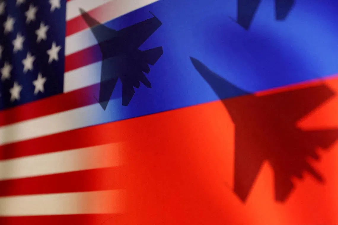FILE PHOTO: Silhouettes of Russian fighter SU-27, U.S. and Russian flags are seen in this illustration taken March 31, 2023. REUTERS/Dado Ruvic/Illustration/File Photo