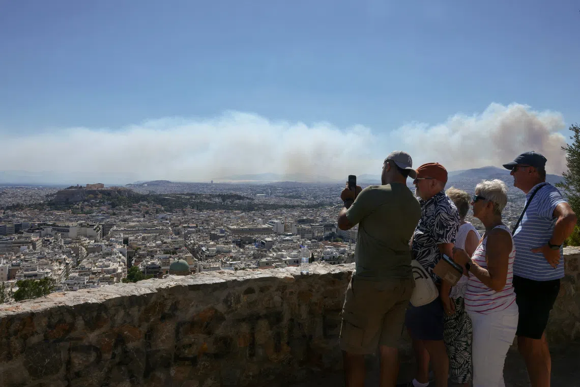 Greece fights fires near Athens as France, Spain improve