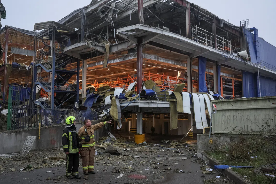 Rescuers work at a site of a shopping mall for household items which was hit by a Russian missile attack, amid Russia's attack on Ukraine, in Kyiv, Ukraine October 22, 2026. REUTERS/Gleb Garanich