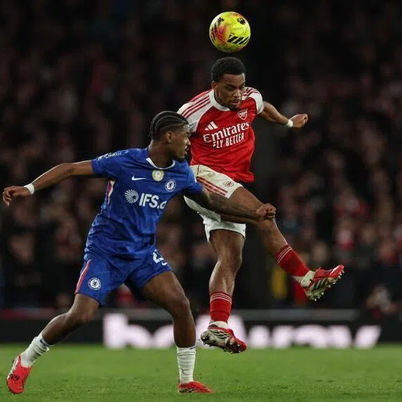 Arsenal's Dutch defender Jurrien Timber (right) clashes with Chelsea's Dutch defender Jorrel Hato during the match at the Emirates Stadium in London.