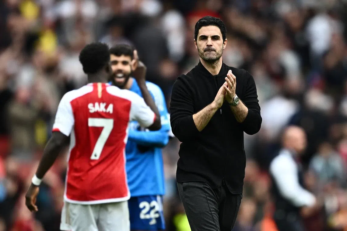 FILE PHOTO: Soccer Football - Premier League - Arsenal v AFC Bournemouth - Emirates Stadium, London, Britain - May 4, 2024 Arsenal manager Mikel Arteta celebrates after the match REUTERS/Dylan Martinez/File Photo