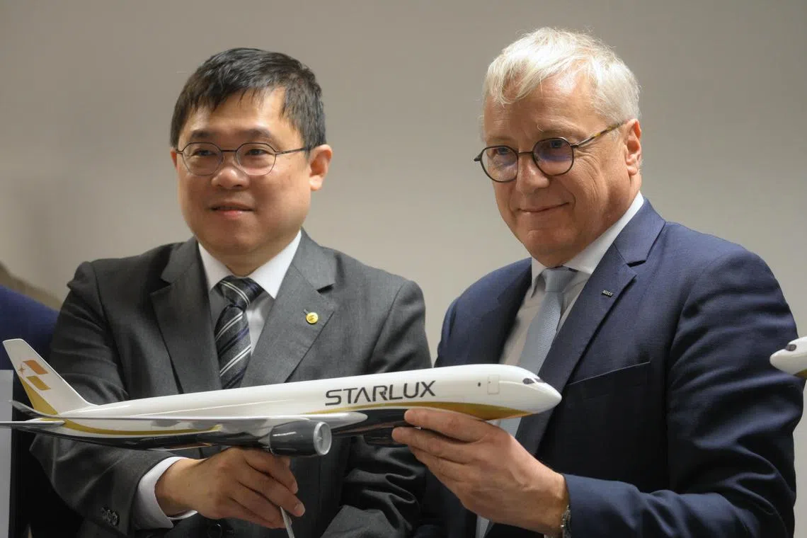 Chang Kuo-wei (left), Chairman of Starlux Airlines shakes hands with Cristian Scherer, CEO of Commercial Aircraft, Airbus, after a commercial announcement on the sidelines of the Singapore Airshow on Feb 21, 2024.