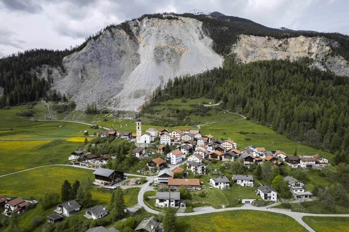 epa10619063 View of the village and the "Brienzer Rutsch", taken on Tuesday, 9 May 2023, in Brienz-Brinzauls, Switzerland. The municipality has closed the access road to the village; residents must evacuate their homes by Friday evening due to an impending rockslide. Two million cubic metres of rock from the mountain above is predicted to come loose and crashing to the valley in the next few days.  EPA-EFE/GIAN EHRENZELLER
