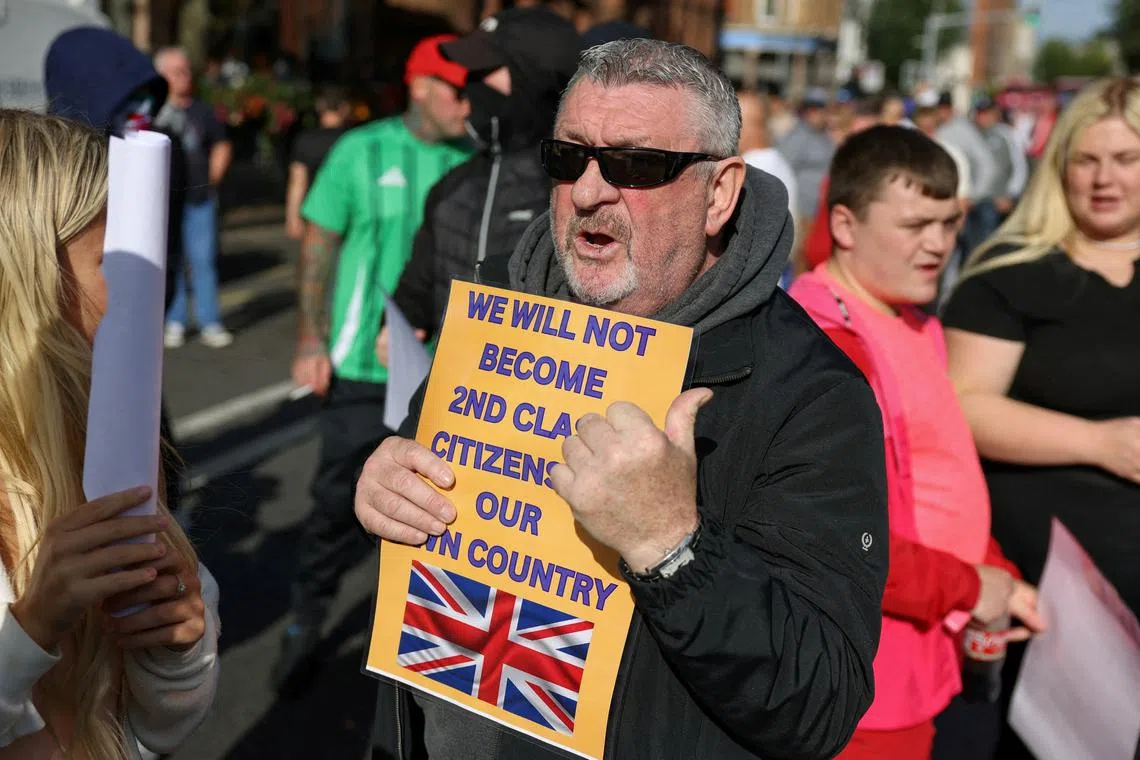 FILE PHOTO: Protesters attend an anti-immigration protest in Belfast, Northern Ireland, August 9, 2024. REUTERS/Hollie Adams/File Photo