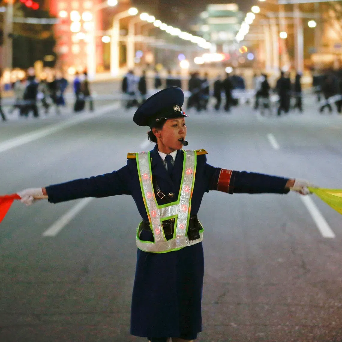 A policewoman controls the traffic as people gather near the main Kim Il Sung square in central Pyongyang, North Korea April 11, 2017.  REUTERS/Damir Sagolj/File Photo