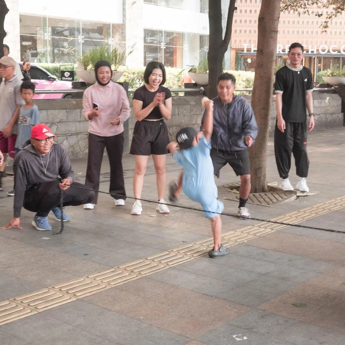 Members of Komunitas Bermain (Playing Community) playing traditional Indonesian children’s games along the car-free day route in Central Jakarta on July 8.