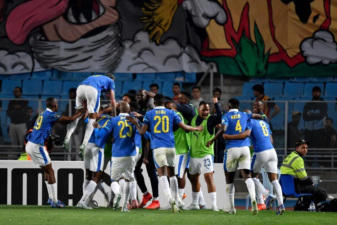 Mamelodi Sundowns players celebrate after scoring the only goal against Esperance Sportive de Tunis in the CAF Champions League semi-finals first leg at the Hammadi Agrebi Stadium in Rades on April 12, 2026.
