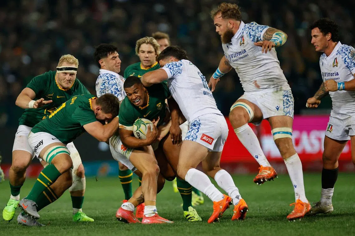 Italy hooker Pablo Dimcheff tackling South Africa fullback Damian Willemse during their international rugby union Test match on July 5.