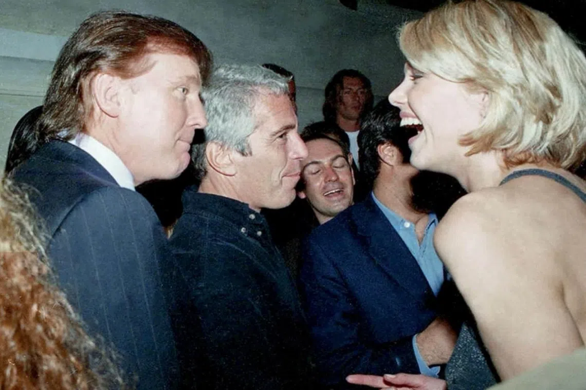 One of the new batch of photos shows US President Donald Trump (far left) with late financier and convicted sex offender Jeffrey Epstein (second from left).