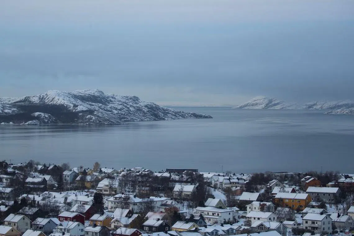 Houses are seen amongst the surrounding landscape of Kirkenes, Norway, October 24, 2019. REUTERS/Maxim Shemetov