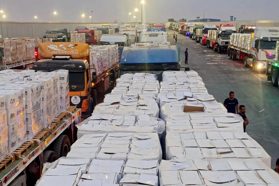 Trucks carrying humanitarian aid lining up near the Rafah border crossing between Egypt and the Gaza Strip, on Aug 13.