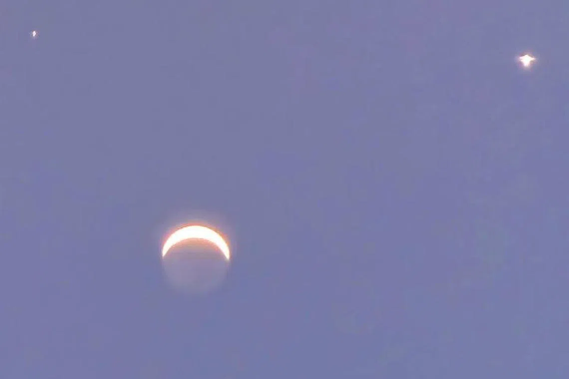 While many parts of the world saw a celestial smiley face, observers in Singapore saw a "sad face" lighting up the pre-dawn sky.