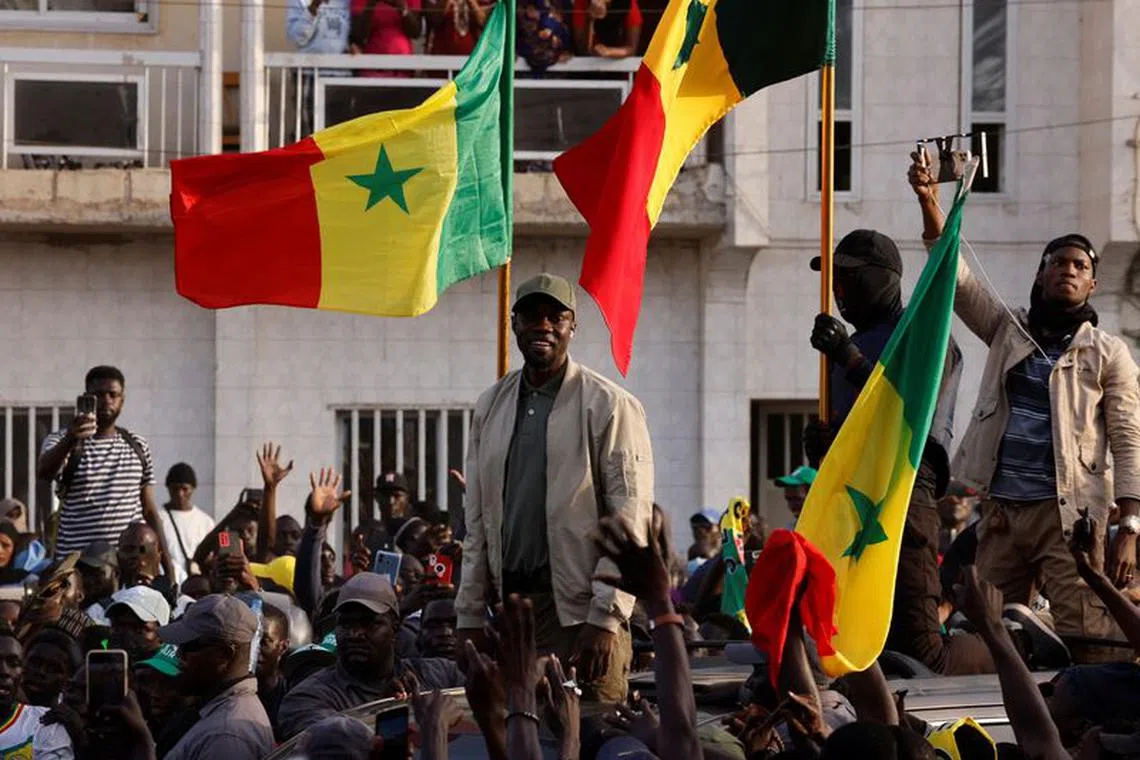 Senegalese opposition leader Ousmane Sonko greets his supporters as he arrives to attend the protest to demand the release of alleged political prisoners ahead of his court appearance on Thursday on libel charges, in Dakar, Senegal March 14, 2023. REUTERS/Zohra Bensemra/File Photo