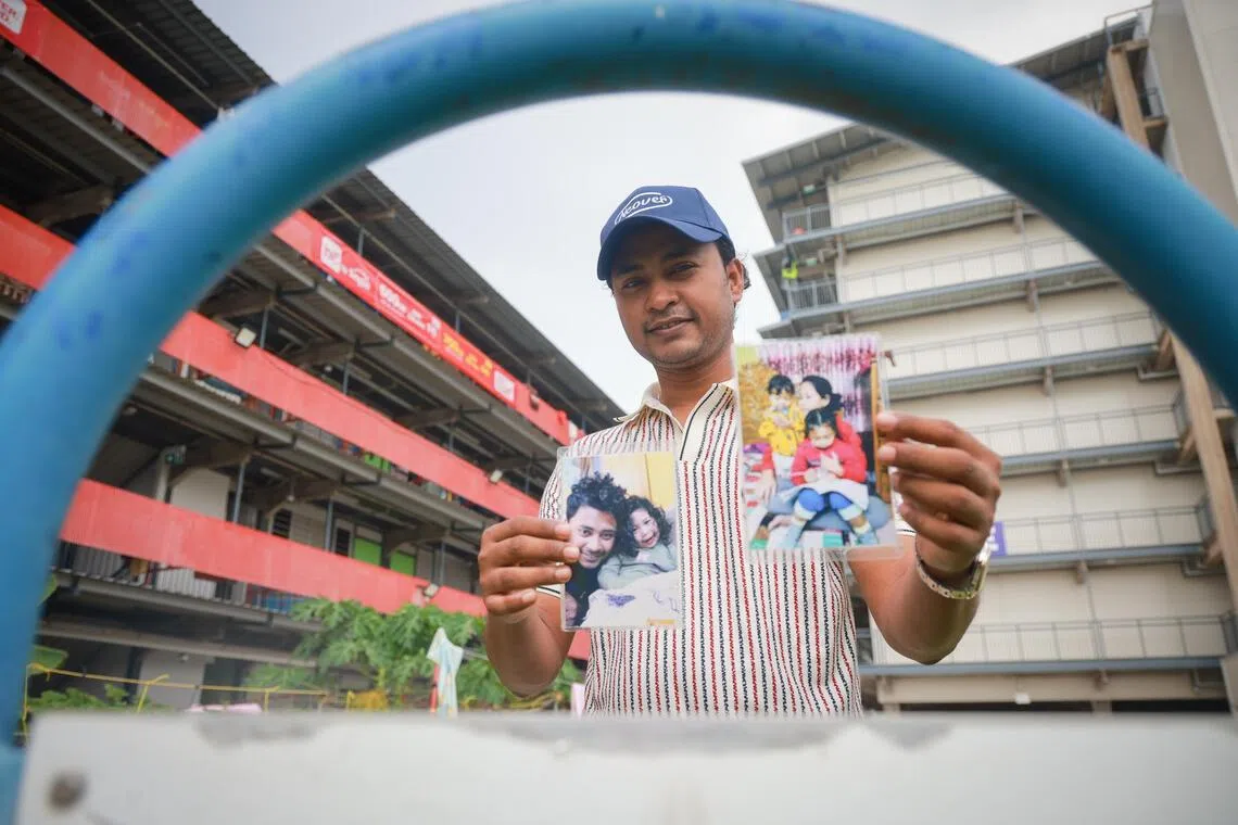 Sayeed Md Abu, a migrant worker who joined the I.C.A.N. Fathering Workshop, with photos of his family. He has two daughters aged 6 and 10.