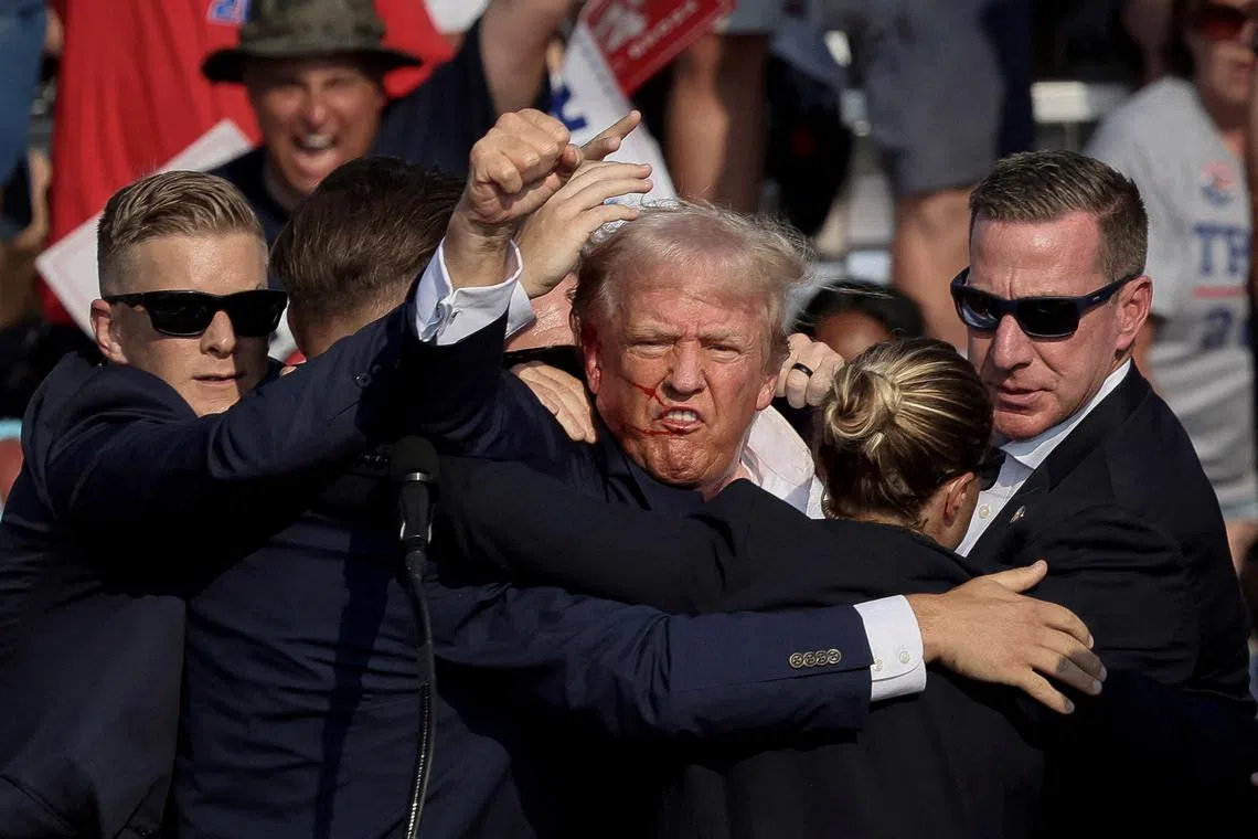 FILE PHOTO: Republican presidential candidate and former U.S. President Donald Trump is assisted by the Secret Service after gunfire rang out during a campaign rally at the Butler Farm Show in Butler, Pennsylvania, U.S., July 13, 2024. REUTERS/Brendan McDermid/File Photo