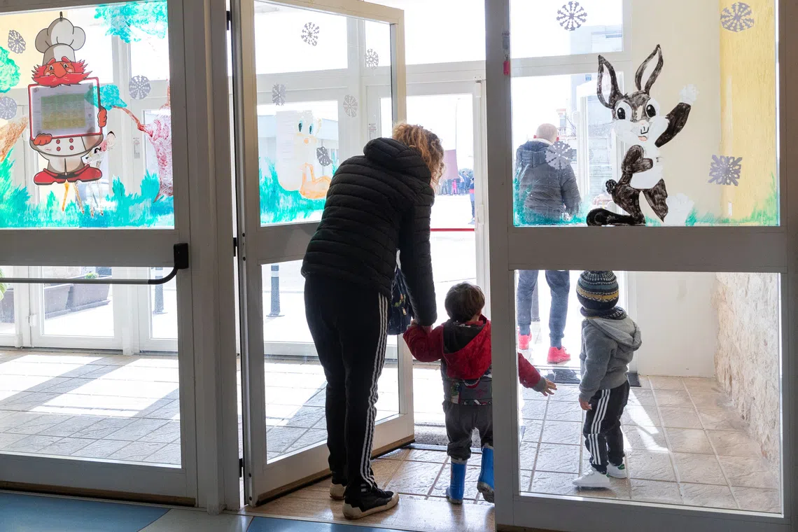 People pick their children up from the nursery in Cisternino, Italy February 13, 2025. REUTERS/Alessandro Garofalo
