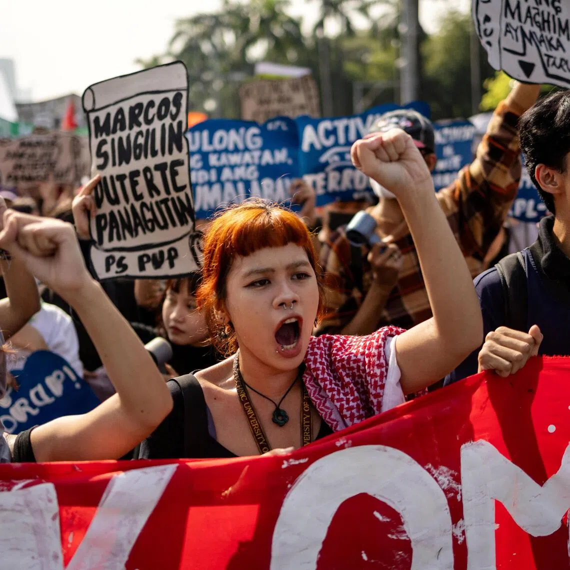 Filipinos shout and raise placards during an anti-corruption protest over widespread corruption allegations linked to government infrastructure projects, on Bonifacio Day in Manila on Nov 30. 