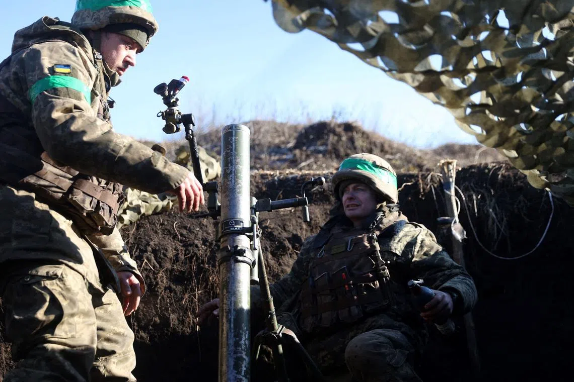 Ukrainian servicemen fire with mortars from their position not far from Bakhmut, in Ukraine's Donetsk region, on Jan 27, 2023.