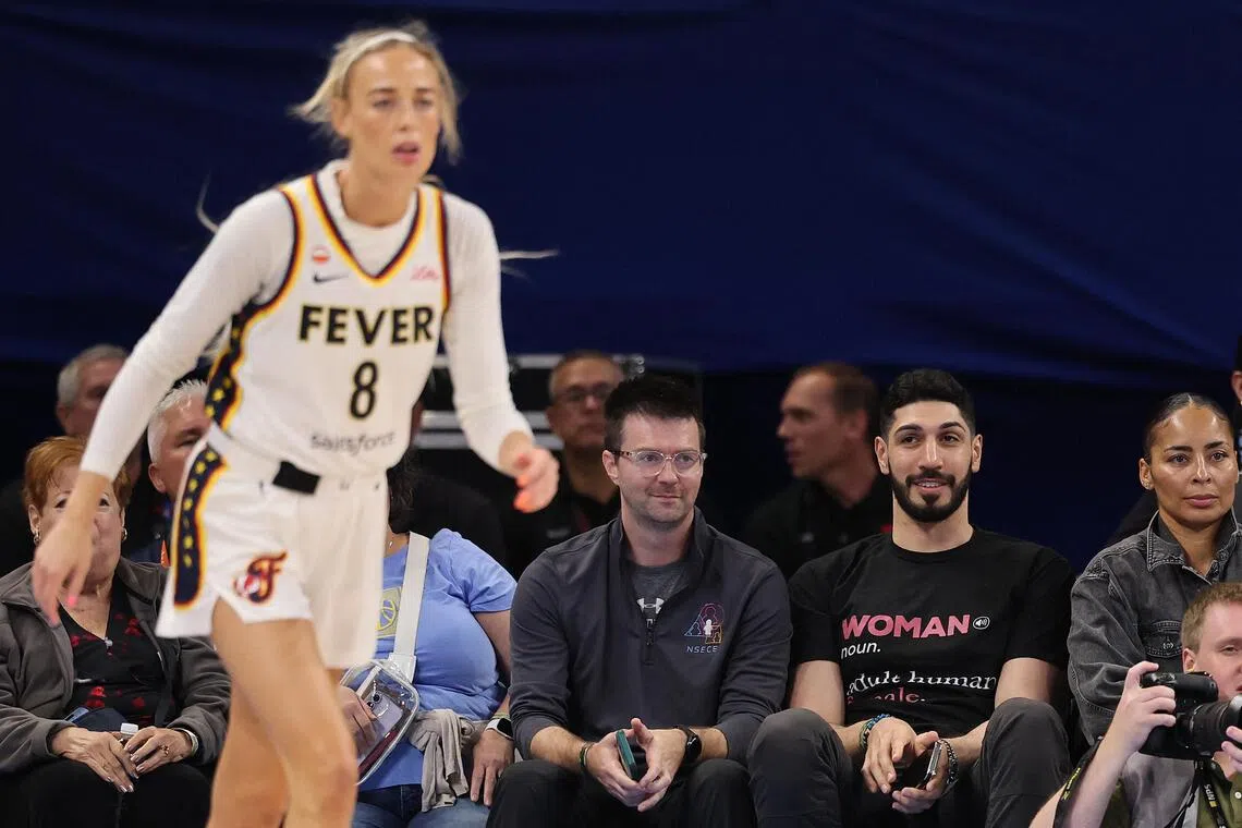 Former basketball player Enes Kanter Freedom (second from right) watching Sophie Cunningham of the Indiana Fever courtside on Aug 23 in Chicago.