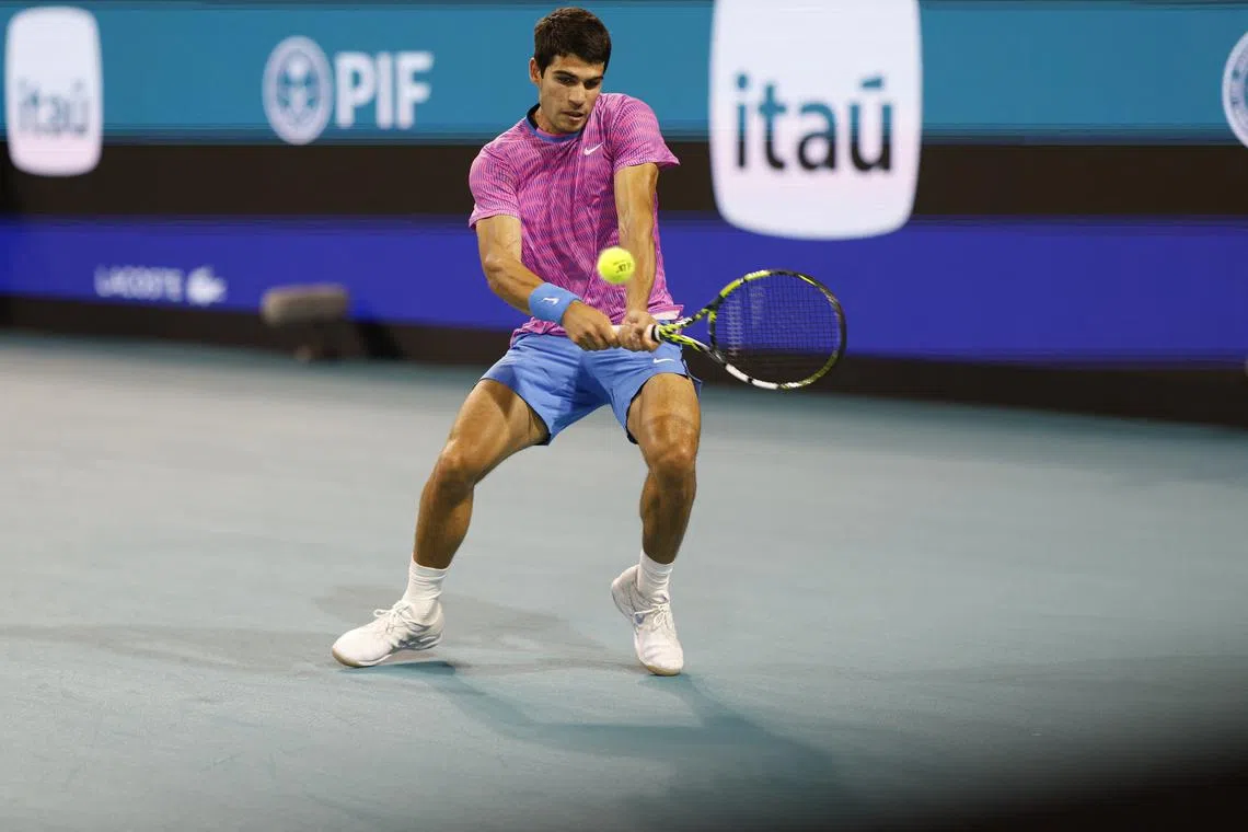 Mar 28, 2024; Miami Gardens, FL, USA; Carlos Alcaraz (ESP) hits a backhand against Grigor Dmitrov (BUL) (not pictured) on day eleven of the Miami Open at Hard Rock Stadium. Mandatory Credit: Geoff Burke-USA TODAY Sports