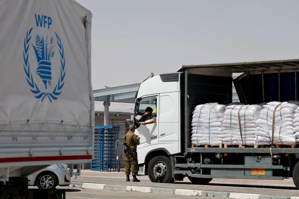 An aid truck is checked by border control before entering Gaza from Israel, at the Kerem Shalom border crossing between Israel and the Gaza Strip, on May 26.