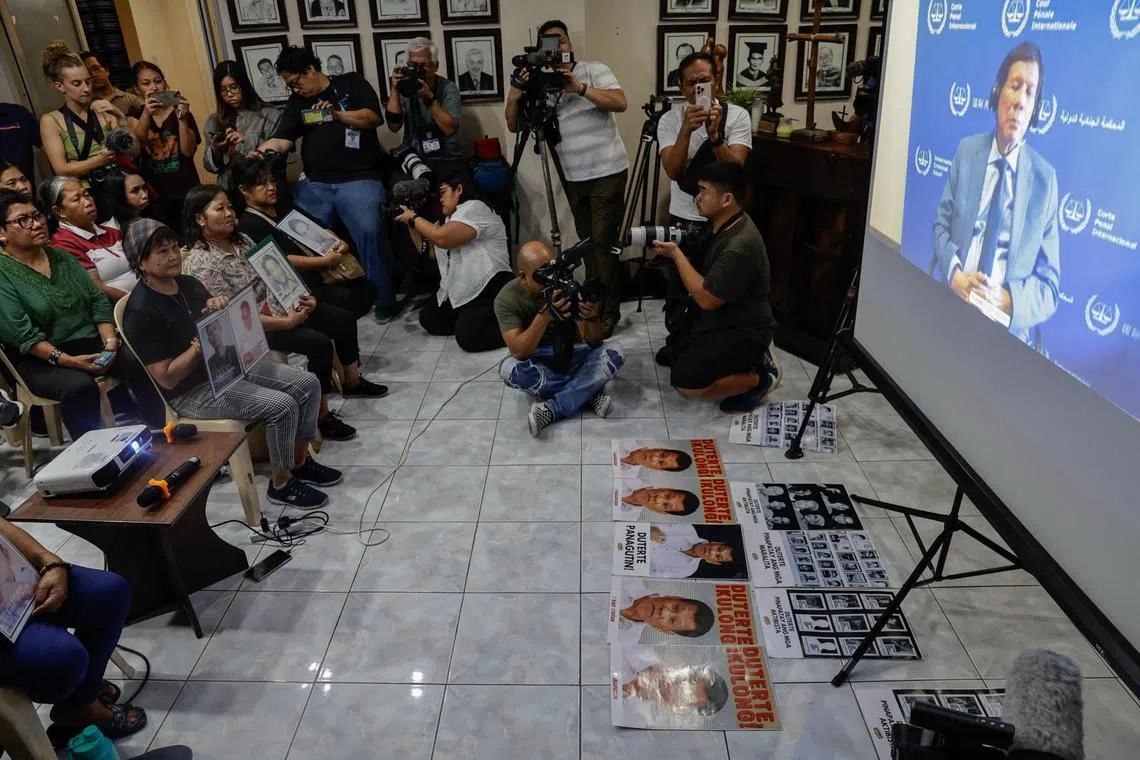 epa11963897 Members of human rights advocacy groups and relatives of victims of alleged extra-judicial killings gather for a live viewing of an International Criminal Court (ICC) hearing in The Netherlands, in Quezon City, Metro Manila, Philippines, 14 March 2025. Former Philippine President Rodrigo Duterte (R, on screen) made an online appearance before a pre-trial chamber of the ICC in The Hague on 14 March, following his arrest on 11 March in Manila. The ICC is investigating Duterte’s war on drugs campaign that resulted in thousands of cases of alleged extra-judicial killings during his term.  EPA-EFE/ROLEX DELA PENA
