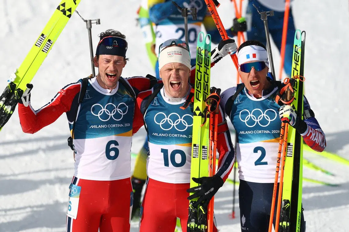 Milano Cortina 2026 Olympics - Biathlon - Men's 15km Mass Start - Anterselva Biathlon Arena, South Tyrol, Italy - February 20, 2026.  Gold medallist Johannes Dale-Skjevdal of Norway celebrates with silver medallist Sturla Holm Laegreid of Norway and bronze medallist Quentin Fillon Maillet of France REUTERS/Matthew Childs