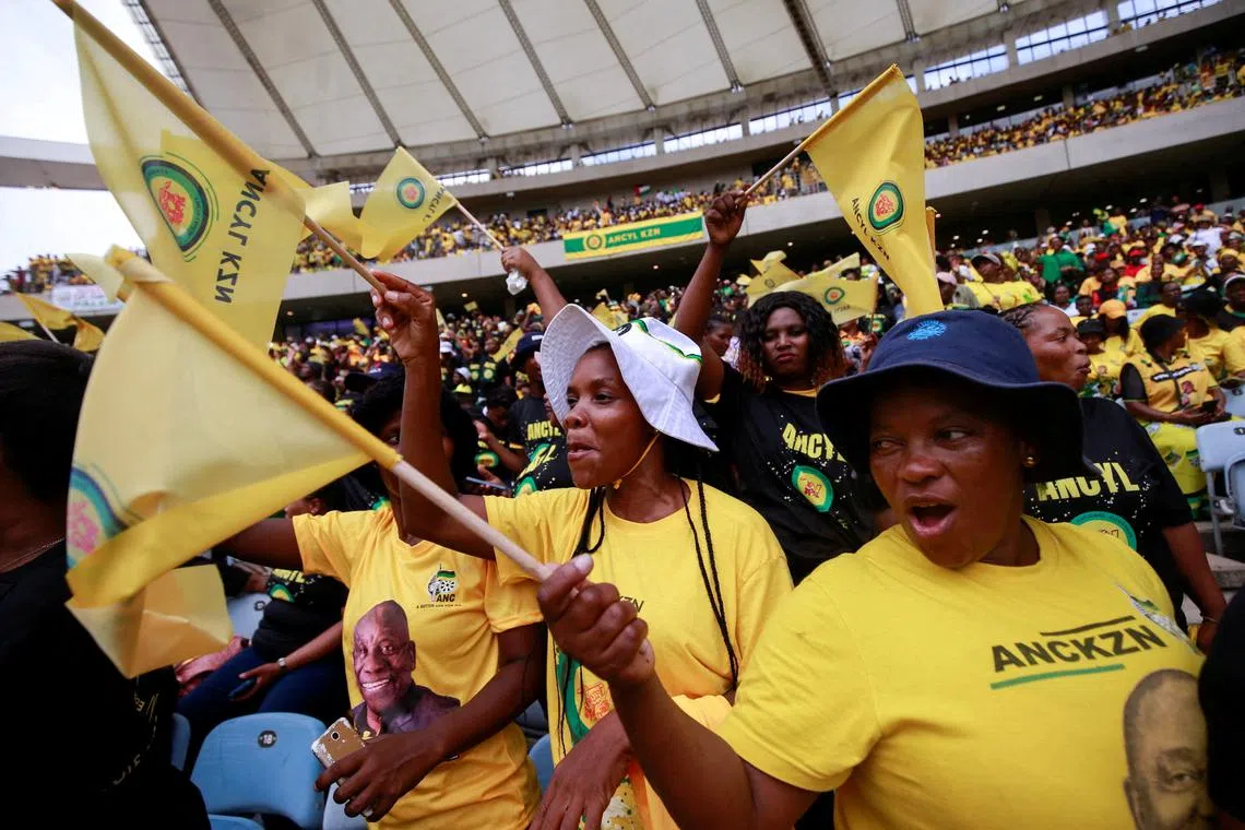FILE PHOTO: Supporters wave flags at the African National Congress Election Manifesto launch in Durban, South Africa, February 24, 2024. REUTERS/Rogan Ward/File Photo