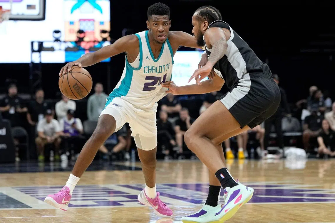 Brandon Miller of the Charlotte Hornets driving to the basket gets fouled by Justin Gorham of the San Antonio Spurs in the second half during the 2023 NBA California Classic at Golden 1 Centre on Monday. The NBA will make its first attempt to crack down on flopping by testing out an in-game penalty during summer league play.