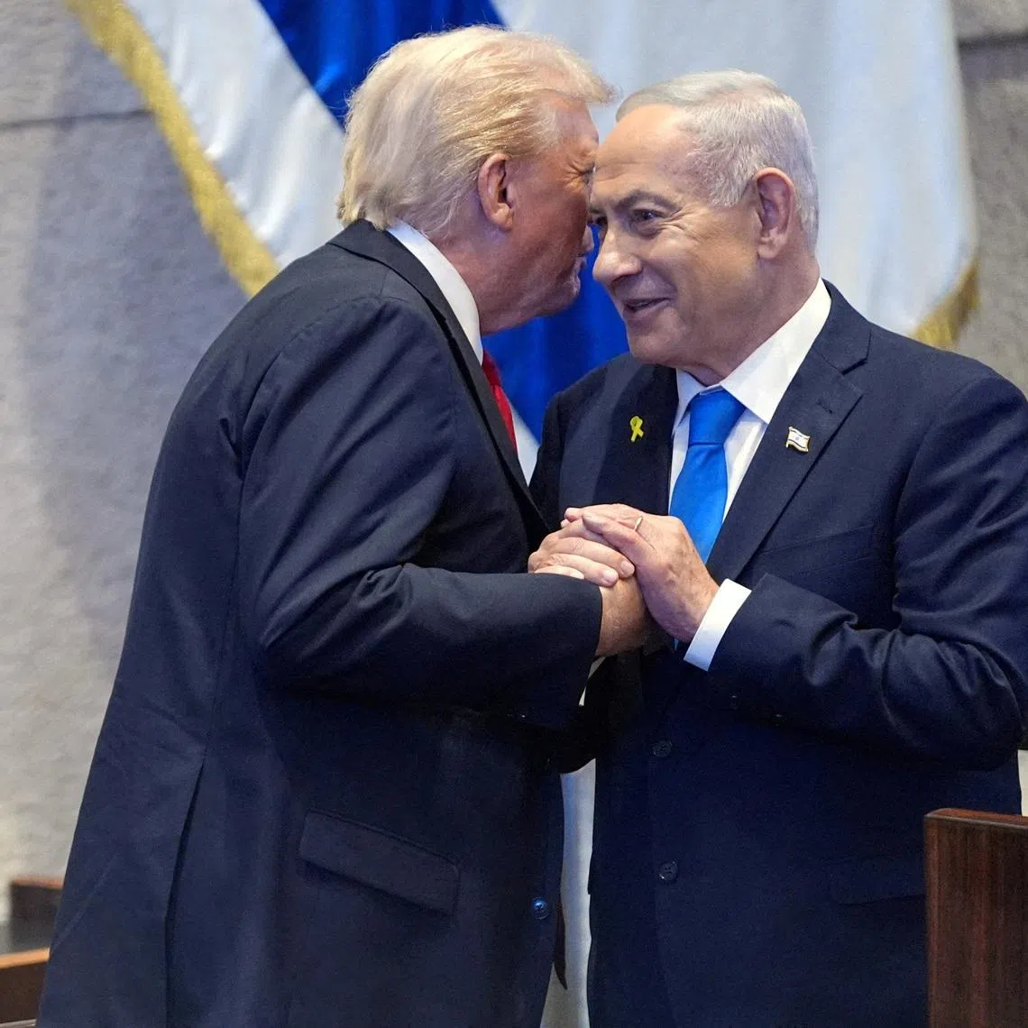 US President Donald Trump talks with Israel's Prime Minister Benjamin Netanyahu at the Knesset, in Oct 2025.