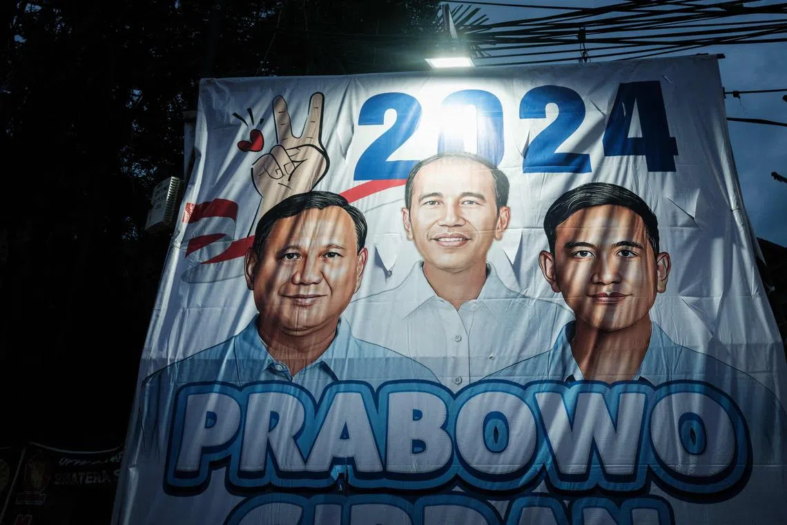 A campaign banner of presidential candidate Prabowo Subianto (L) and vice presidential candidate Gibran Rakabuming Raka (R), son of President Joko Widodo, are seen along a street in Jakarta on Jan 31, 2024. At the centre of the banner is an image of Mr Widodo.