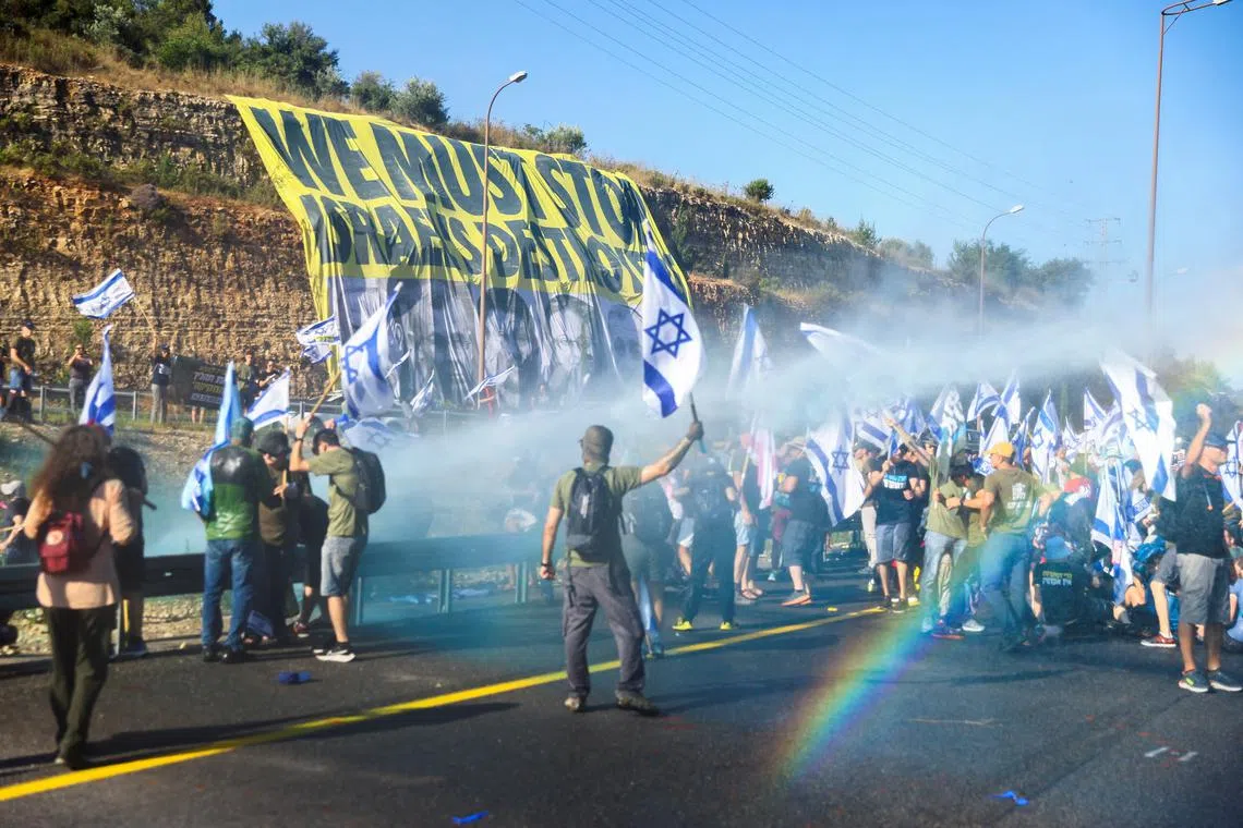 People block a highway to Jerusalem in protest against Israeli Prime Minister Benjamin Netanyahu and his nationalist coalition government's judicial overhaul, on July 11.