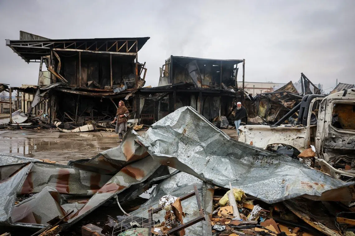 FILE PHOTO: Afghan men walk next to debris lying at the site of a drug rehabilitation center destroyed in what the Taliban said was a Pakistani air strike in Kabul, Afghanistan, March 18, 2026. REUTERS/Sayed Hassib/ File Photo