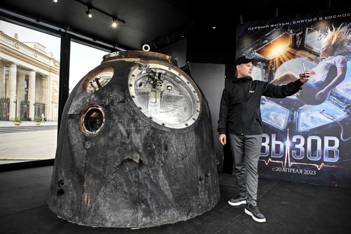 A man makes a selfie next to the Russian Soyuz MS-18 space capsule which brought back to the Earth on Oct 17, 2021 Russian actress Yulia Peresild, in Moscow on April 18, 2023.