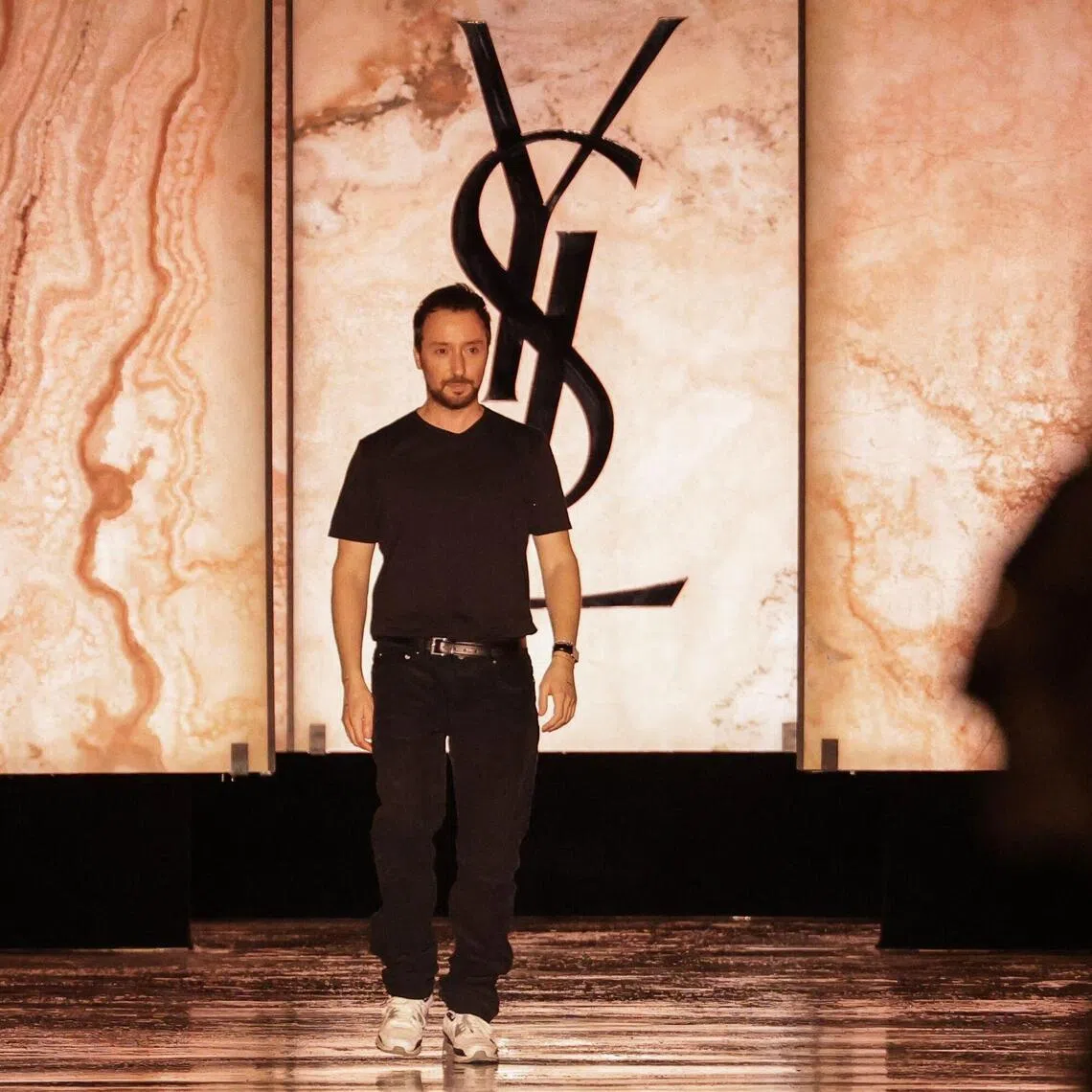 (FILES) Belgian-Italian fashion designer Anthony Vaccarello reacts after the presentation of creations by Saint Laurent for the Womenswear Ready-to-wear Fall-Winter 2025/2026 collection as part of the Paris Fashion Week, in Paris on March 11, 2025. French fashion house Saint-Laurent announces on October 9, 2026 the departure of its creative director Anthony Vaccarello. (Photo by Thibaud MORITZ / AFP)