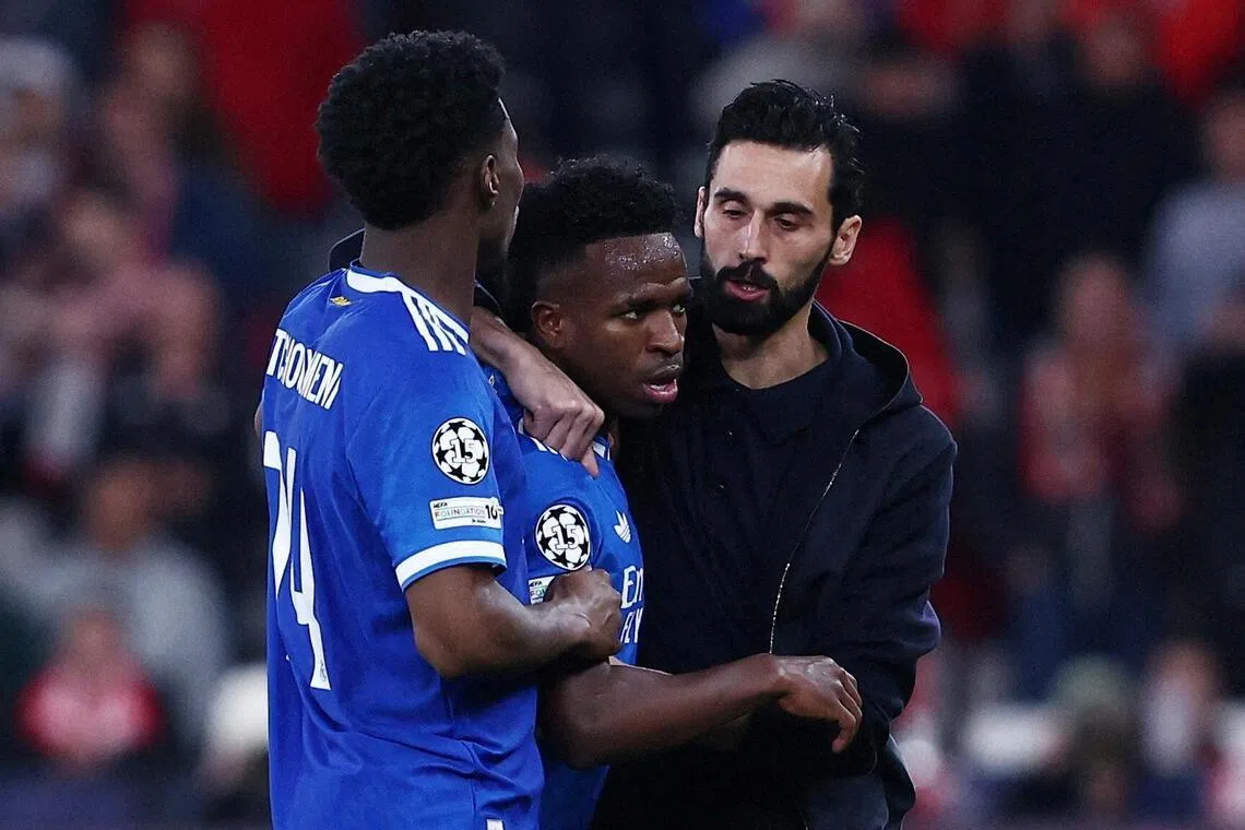 Real Madrid's Vinicius Jr with coach Alvaro Arbeloa and Aurelien Tchouameni, as the Feb 17 match against Benfica was stopped due to racist chants.