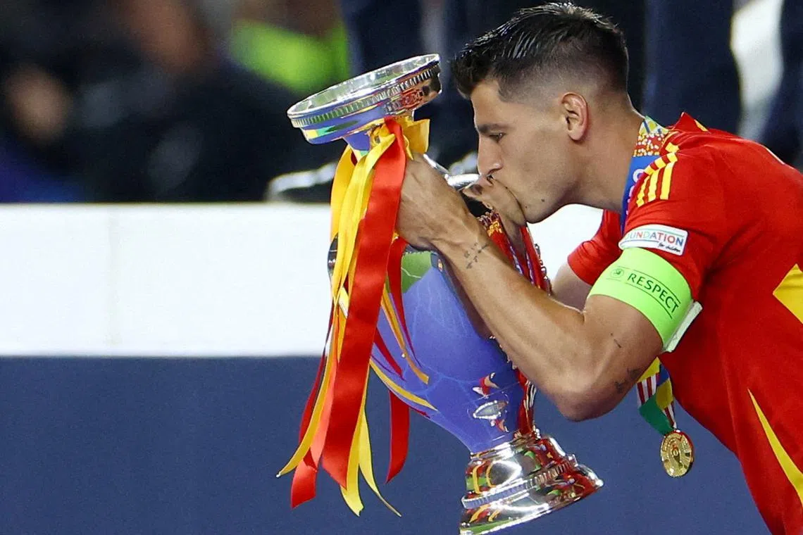 FILE PHOTO: Soccer Football - Euro 2024 - Final - Spain v England - Berlin Olympiastadion, Berlin, Germany - July 14, 2024 Spain's Alvaro Morata celebrates with the trophy after winning the final REUTERS/Lisi Niesner/File Photo