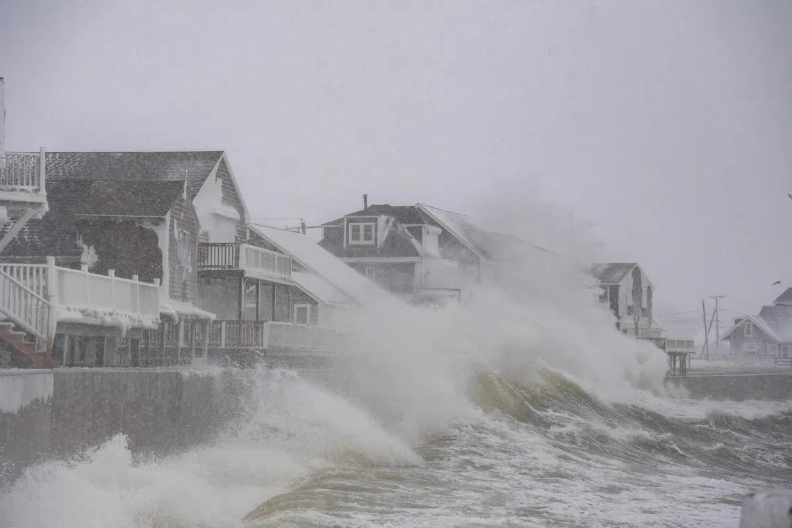 High waves pounding houses on the shoreline in Scituate, Massachusetts, U.S on Feb 23, 2026. Tens of millions of Americans from the US capital Washington to the northern state of Maine prepared for up to two feet (60 centimeters) of snow forecast in some areas. 