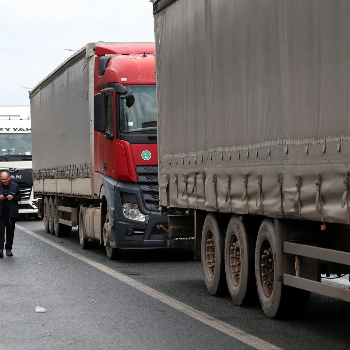 A truck driver walks during a protest by truck drivers and transport union representatives at the Serbia-Croatia border crossings, citing disruptions linked to the European Union's new Entry-Exit System (EES), in Batrovci, Serbia, January 26, 2026. REUTERS/Zorana Jevtic