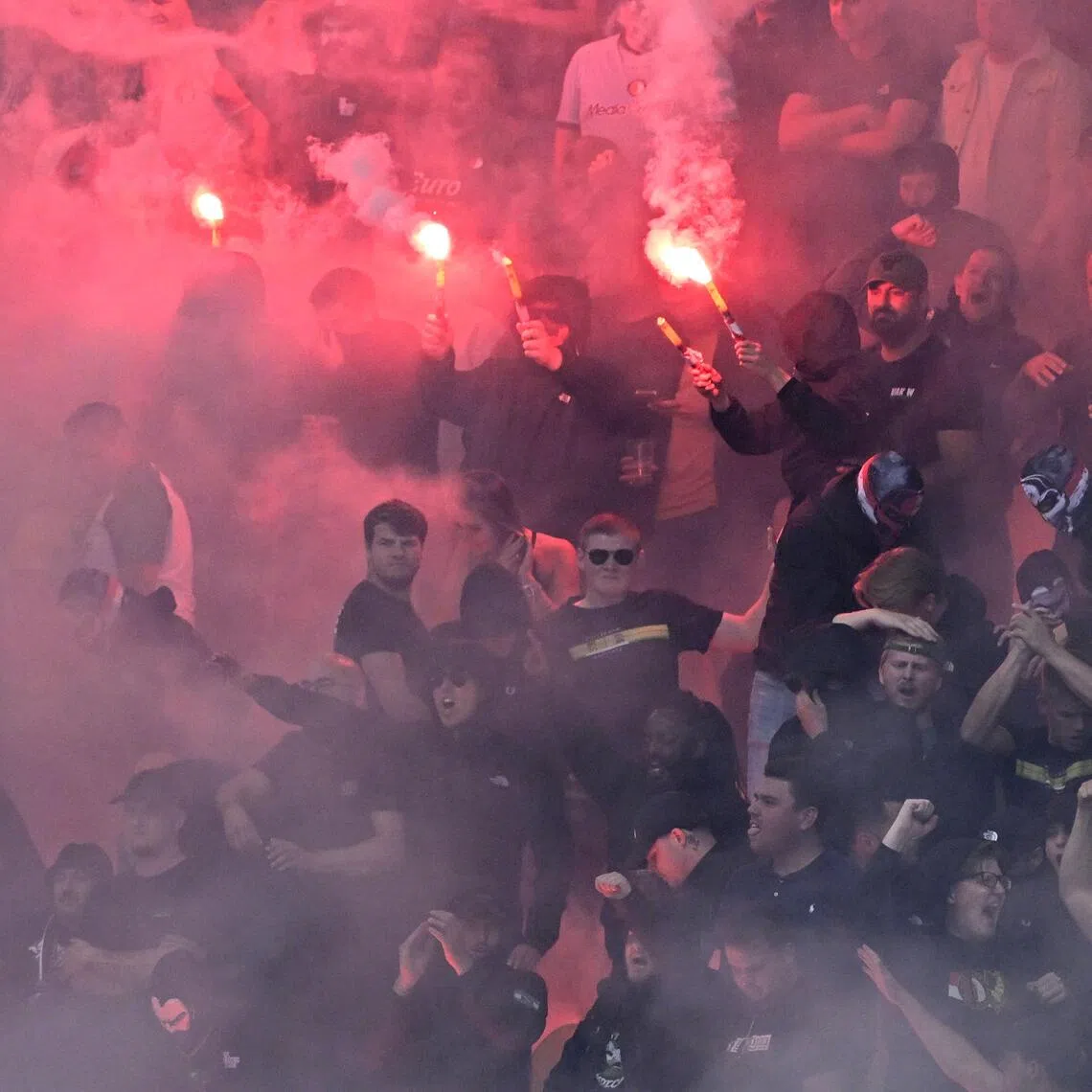 Feyenoord fans setting off flares during the Dutch Eredivisie match against SC Cambuur at the Kooi Stadion in Leeuwarden, the Netherlands on Aug 23.