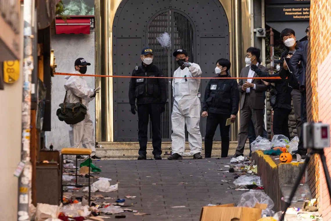 Crime scene and forensic investigators at the site of a deadly crowd crush during Halloween festivities in the Itaewon district of Seoul, South Korea, on Monday, Oct. 31, 2022. The deadly surge of revelers in Seoul's Itaewon district on Saturday night hit citizens from at least 15 nations, prompting an outpouring of grief and offers of help from governments around the world.Photographer: SeongJoon Cho/Bloomberg