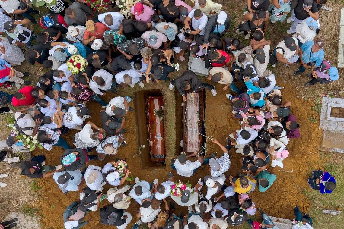 Aerial view of people attending the mass burial of the victims of a highway bombing at the local cemetery in Cajibio, Cauca department, Colombia on April 28, 2026.