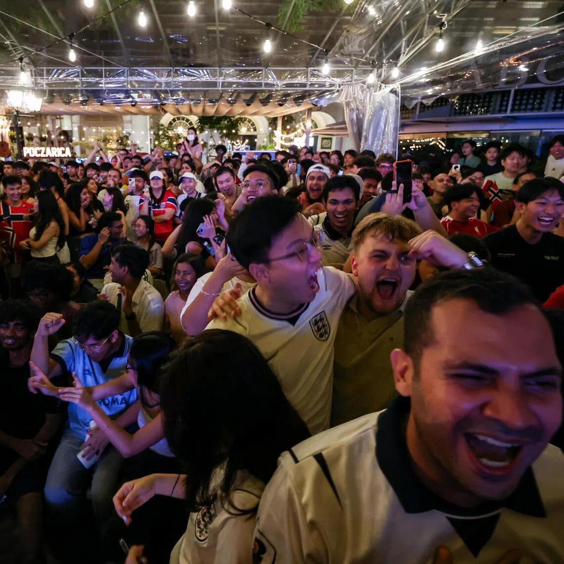 England fans at Chijmes celebrating after Jude Bellingham equalised for the Three Lions in their World Cup quarter-final win over Norway.