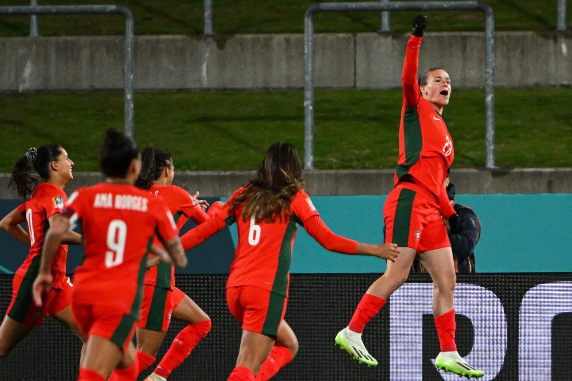 Telma Encarnacao celebrates with her teammates after scoring Portugal's first goal.