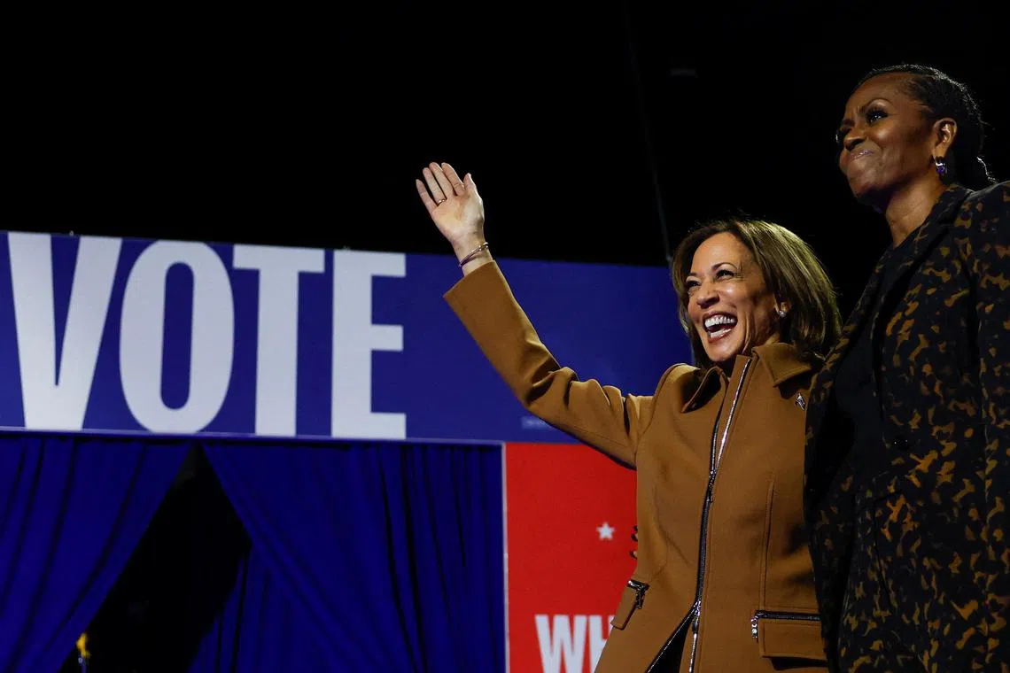 Democratic presidential nominee U.S. Vice President Kamala Harris and Former U.S. first lady Michelle Obama attend a campaign event for Harris at Wings Event Center in Kalamazoo, Michigan, October 26, 2024. REUTERS/Evelyn Hockstein
