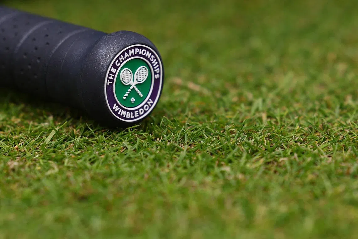 FILE PHOTO: Tennis - Wimbledon - All England Lawn Tennis and Croquet Club, London, Britain - July 5, 2024 The Wimbledon logo is pictured on the handle of a racket REUTERS/Paul Childs/File Photo