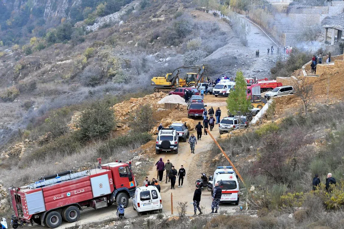Rescue workers and people gathering at the site of an Israeli airstrike, in the Mount Lebanon area, east of Beirut, on Nov 12.
