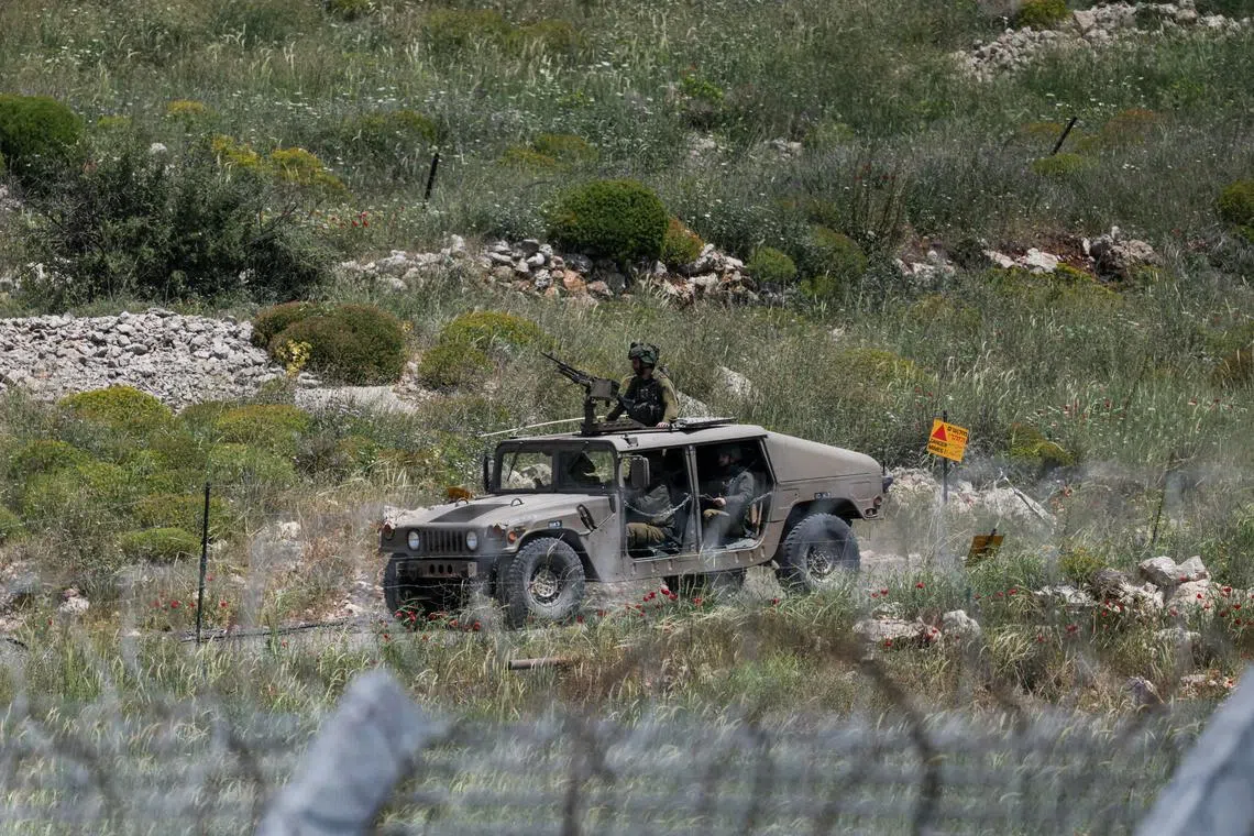FILE PHOTO: An Israeli military vehicle is seen near the border between the Israeli-occupied Golan Heights and Syria, May 4, 2025. REUTERS/Shir Torem/File Photo
