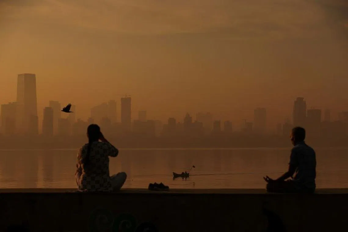 FILE PHOTO: People exercise at a promenade on a smoggy morning in Mumbai, India, December 9, 2022. REUTERS/Francis Mascarenhas      TPX IMAGES OF THE DAY/File Photo