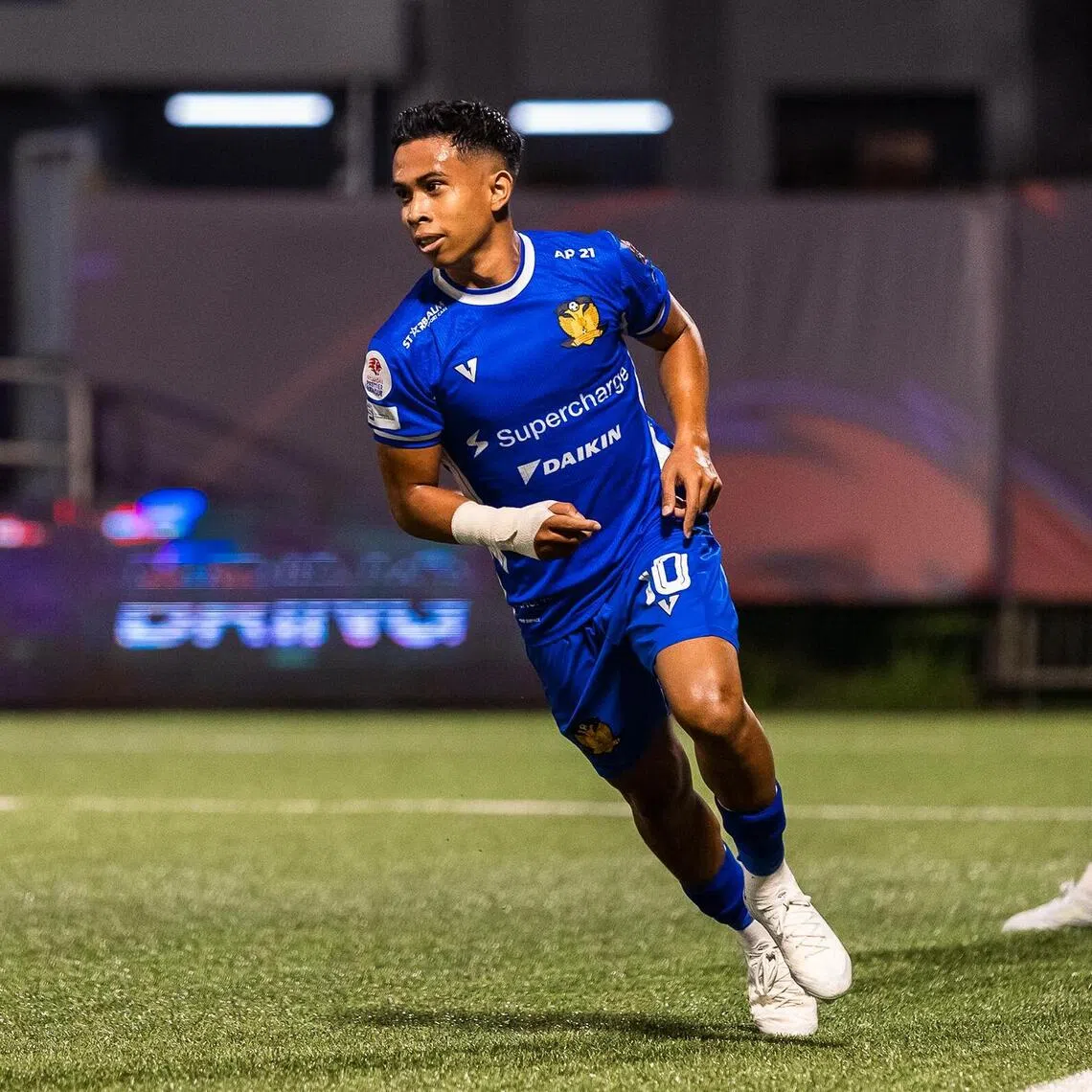Hougang United winger Farhan Zulkifli wheels away to celebrate after scoring the opening goal in their 3-2 Singapore Cup group win over Tanjong Pagar United as goalkeeper Kenji Rusydi and defender Faizal Roslan look on in disappointment.